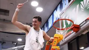 John Poulakidas cuts down the nets for Yale Basketball after winning the Ivy League Conference Tournament.