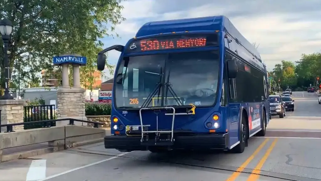 PACE bus on Naperville street next to Naperville sign