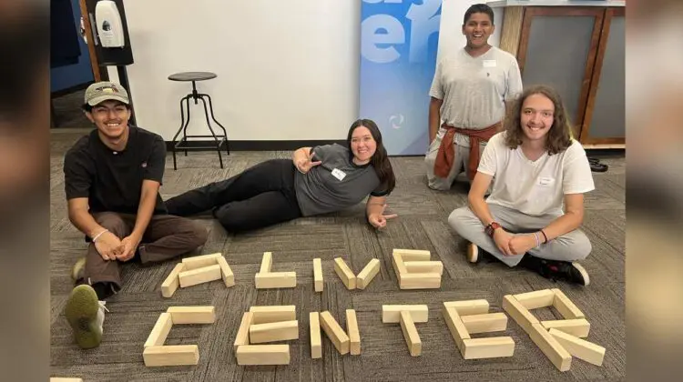 Teens at Alive Center with blocks spelling out the words Alive Center