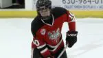 Benet Academy hockey player warms up before playing Providence.