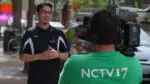 An NCTV17 reporter stands in front of a video camera held by an NCTV17 photographer.