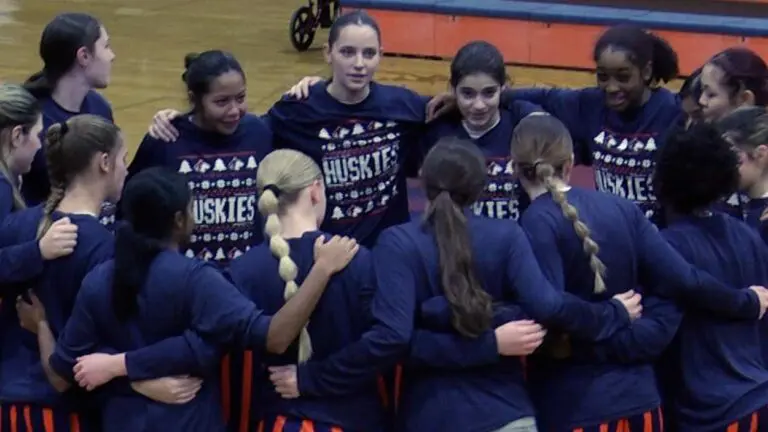 Naperville North girls basketball huddles up before playing Metea Valley.