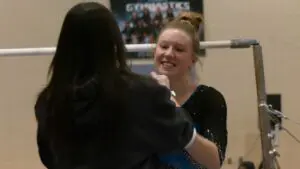 Bridget Anderson smiles and high fives with her Valley Co-Op coach.