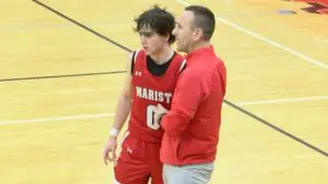 Marist boys basketball player and coach talk during the game against Waubonsie.