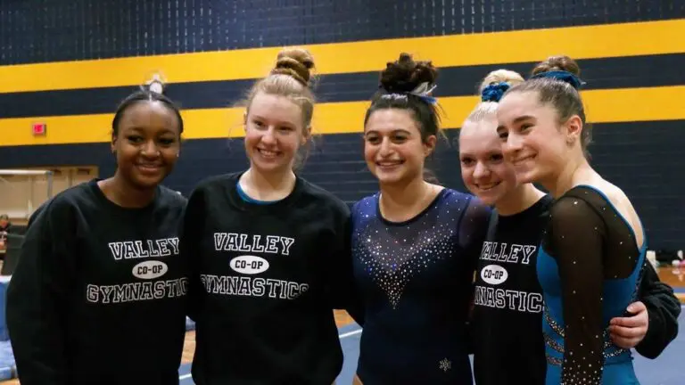 Valley Co-Op Gymnastics and Naperville North gymnasts smile for a picture after the competition.