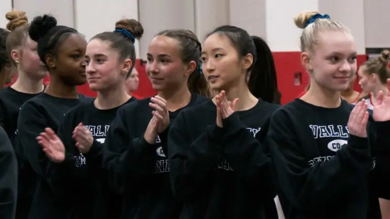 Valley Co-Op gymnasts line up against Naperville Central.