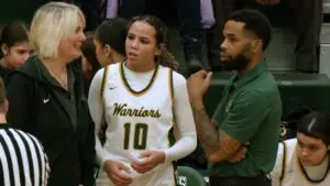 Waubonsie Valley girls basketball coaches and Danyella Mporokoso talk during the game against Metea.