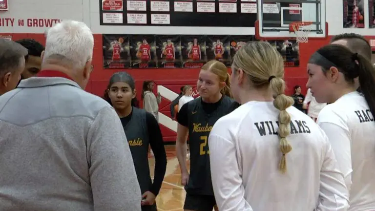 Waubonsie Valley girls basketball and Naperville Central captains meet up at halfcourt before the game.