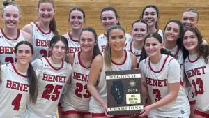 Benet girls basketball team smiles with Lindsay Harzich holding the Regional plaque.