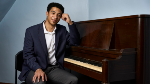 Elijah Darden sitting at piano.