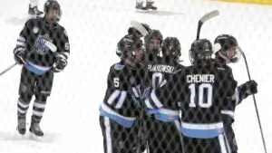 Josh Pijanowski celebrates with his teammates from Warriors Hockey.