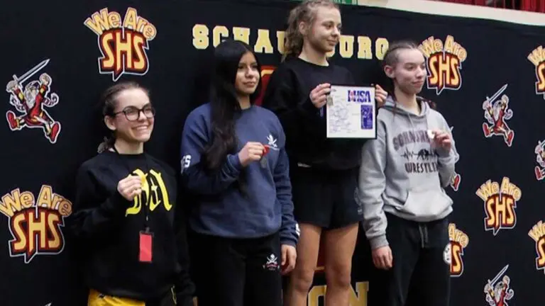 IHSA Girls Wrestling competitors, including Ashley Basmajian, smile for the awards at 115.