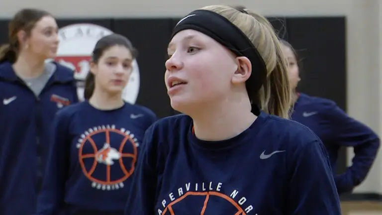 Naperville North girls basketball players warm up