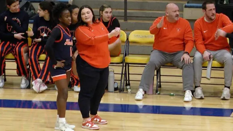 Naperville North girls basketball team talks in between plays against Neuqua.