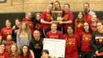 Batavia smiles with the Girls IHSA Wrestling Regional plaque at Hinsdale South.