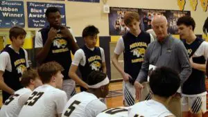 Neuqua boys basketball team huddles up in the DVC finale against Naperville North.