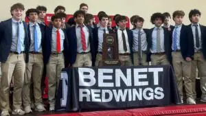 Benet Academy boys basketball team smiles with the state championship trophy.