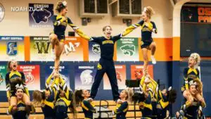 Nathan Malinowski in the middle being lifted up by the Neuqua Valley cheerleading team.