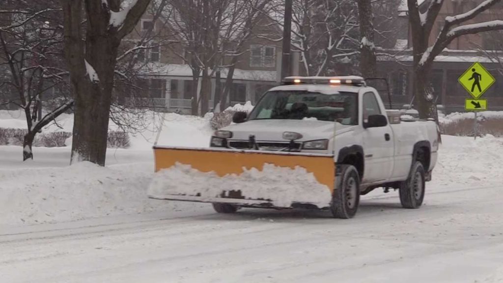 Snowplow truck tackling winter snow