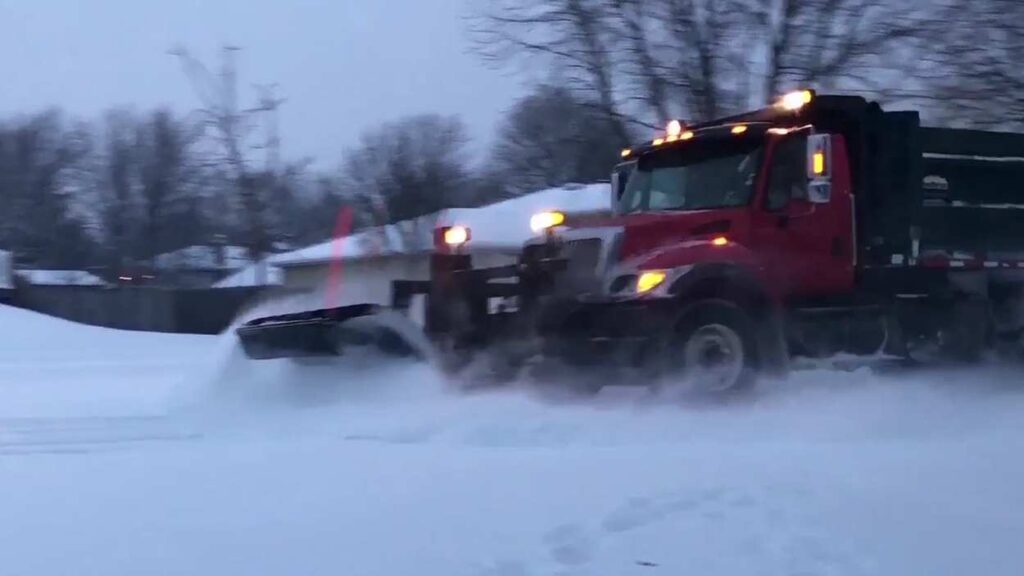 Snowplow clearing snow from street