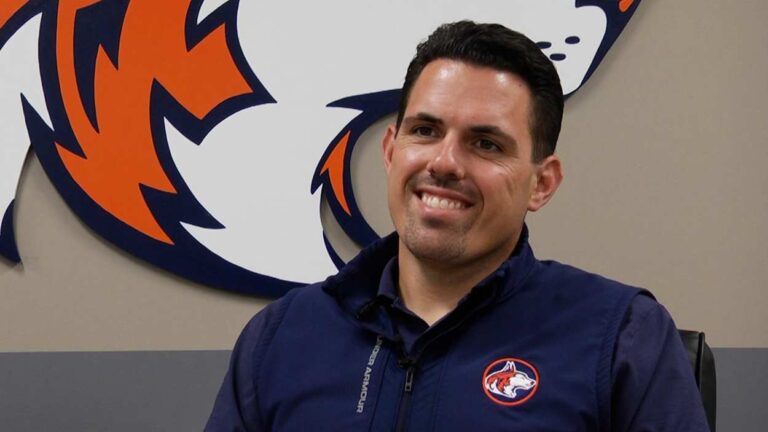 Jon Pereiro smiles while talking at Naperville North High School.