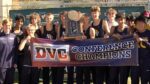 Neuqua Valley runners celebrate with the cross country DVC Championship trophy and banner.