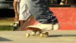 close up of feet on skateboard at skateboarding mental health event