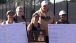 Waubonsie Valley girls tennis team celebrates with the sectional plaque.