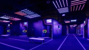 Purple lit game hall at Activate Games