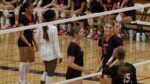 Benet girls volleyball players talk in between sets against Wheaton South.