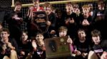 Edwardsville Boys Soccer players celebrate with the Super-Sectional plaque after beating Naperville Central