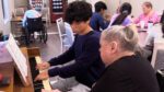 Haven Music Group's Ricky Kim playing piano with a senior resident