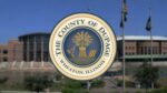 DuPage County seal over blurred image of DuPage County building