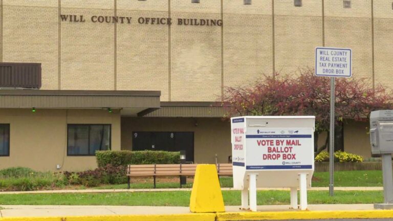 Will County Office Building with a vote by mail box in front of it.