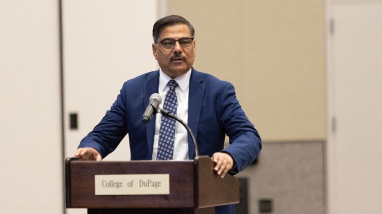 New College of DuPage president Dr. Muddassir Siddiqi standing at podium